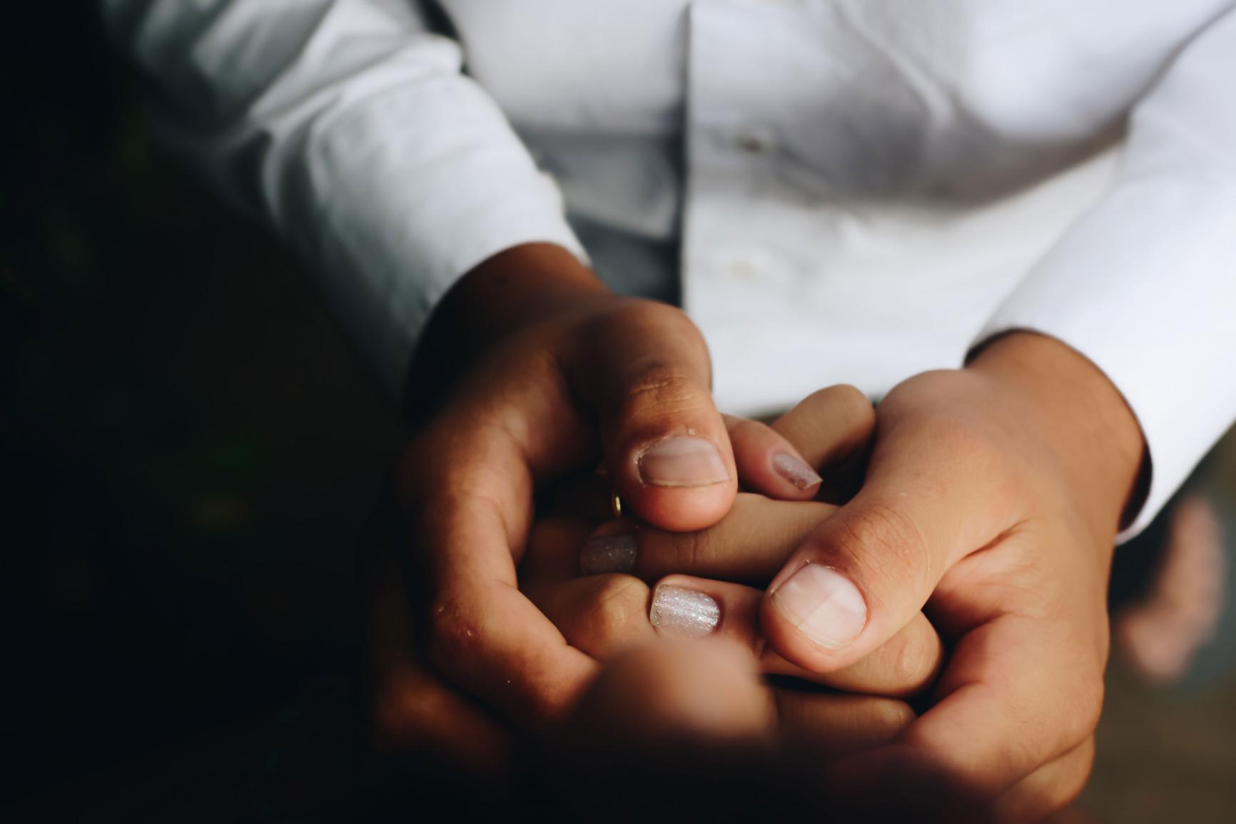 Doctor and patient holding hands
