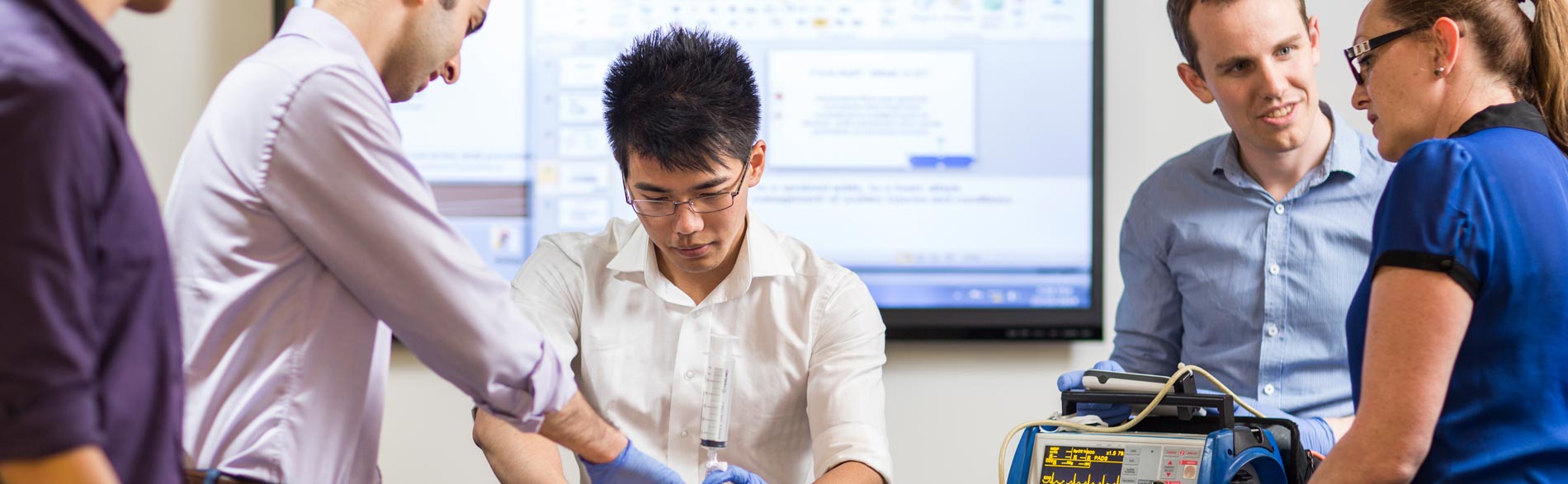 Student clinicians practicing a procedure in an Adelaide Health Simulation room 