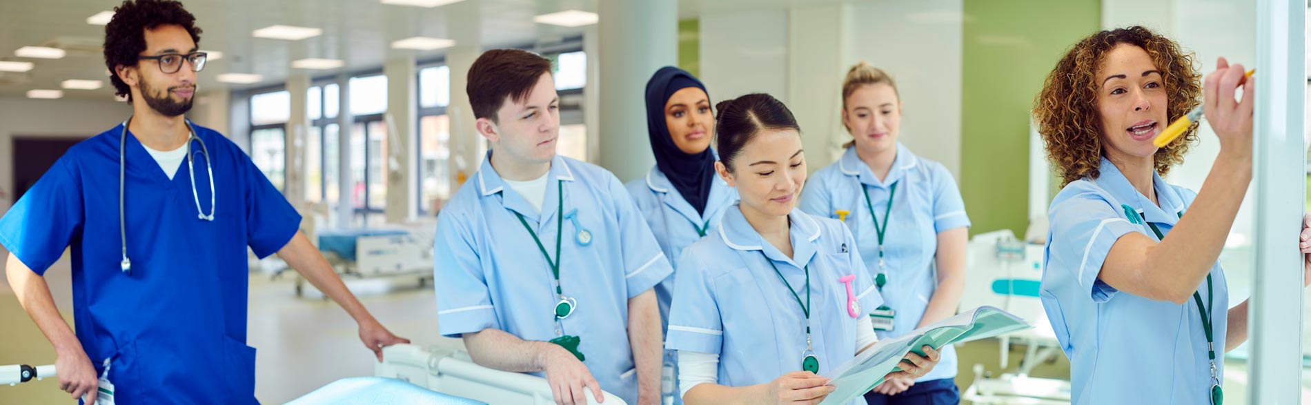 A clinician teaching her students about broader societal factors that impact health
