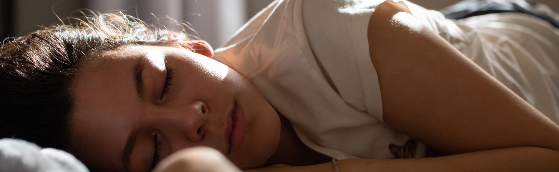 An adolescent girl sleeping with the assistance of a School-Based Sleep Programs