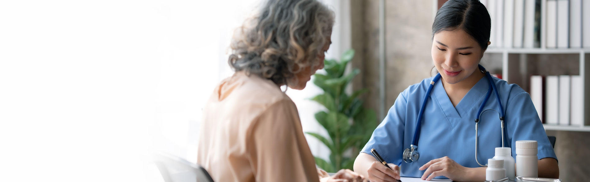 Clinician performing a pre-chemotherapy assessment on a patient