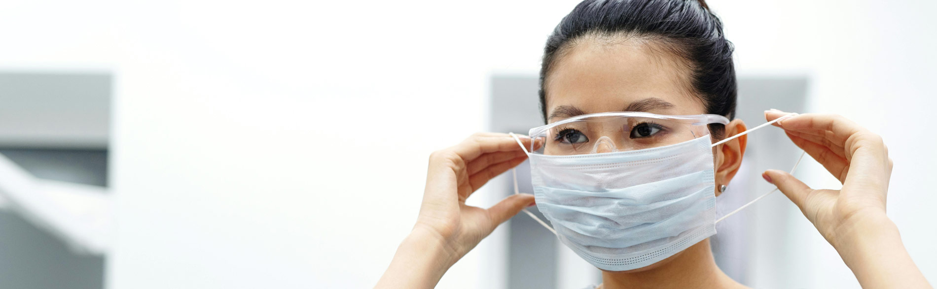 Clinician puts on personal protective equipment as part of effective quality improvement