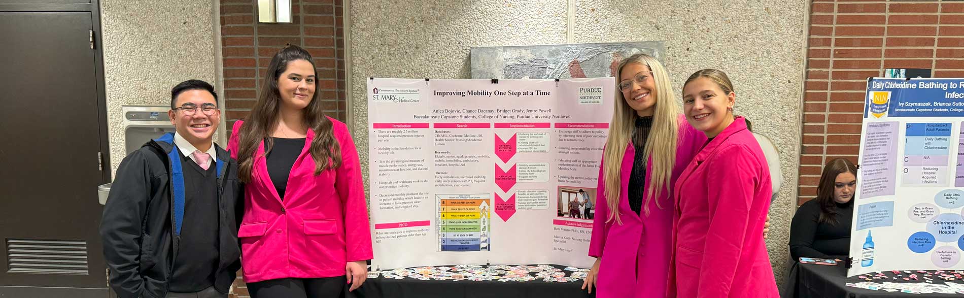 Members of the Indiana Center for Evidence Based Nursing Practice presenting their institute poster at an exhibition