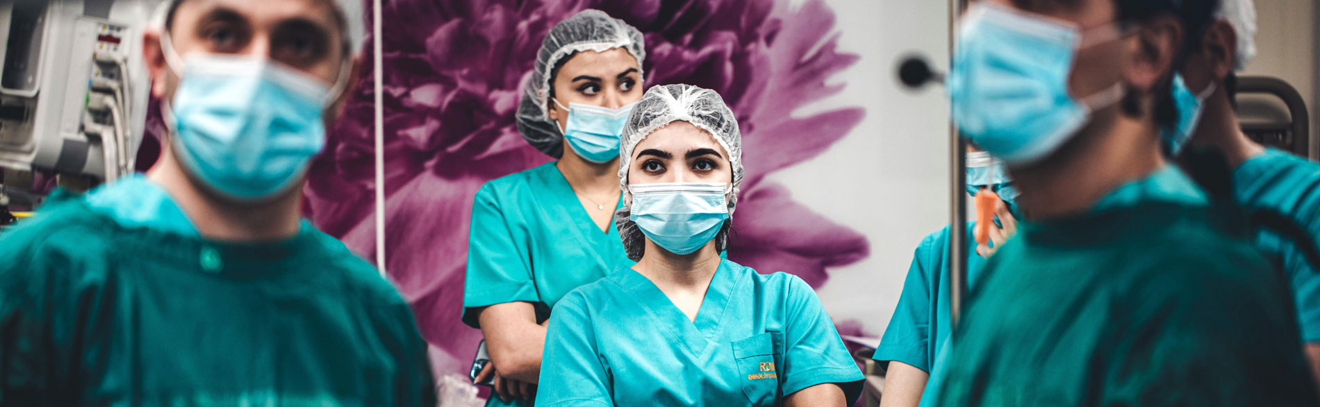 Clinicians standing in an operating theatre