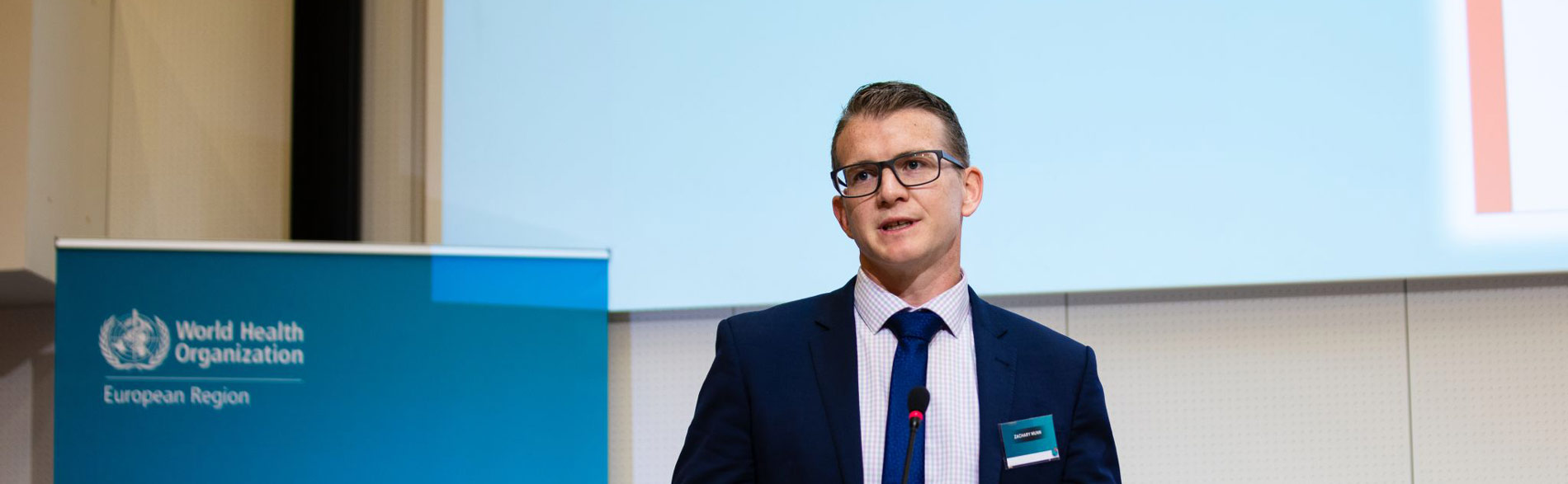 Prof Zac Munn speaking at a World Health Organization event