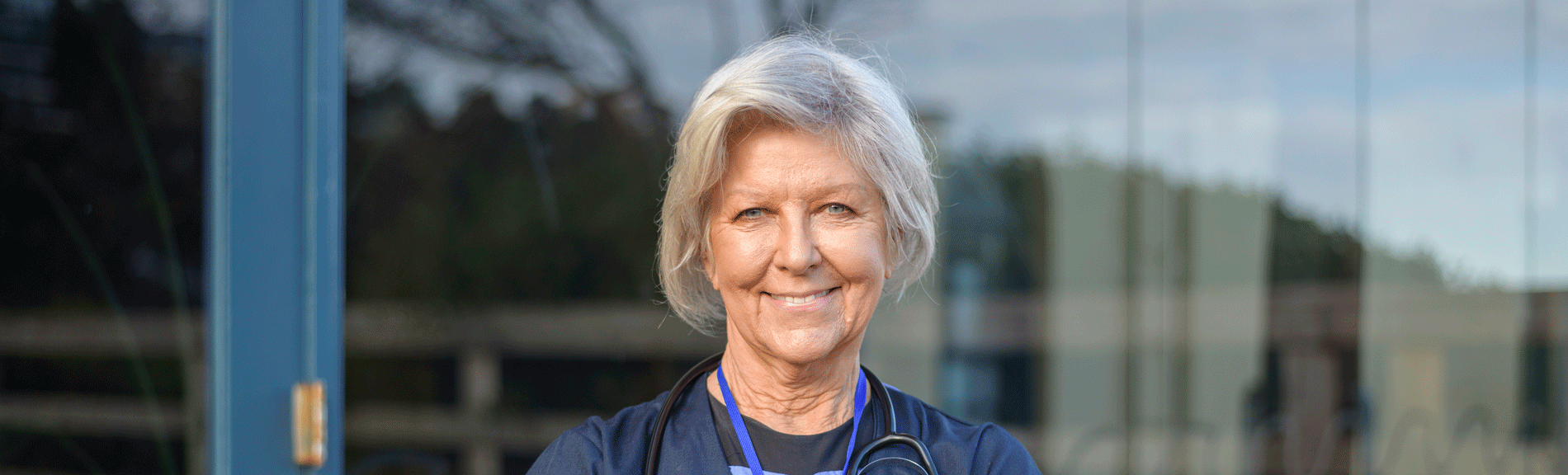 Australian midwife stands outside of hospital