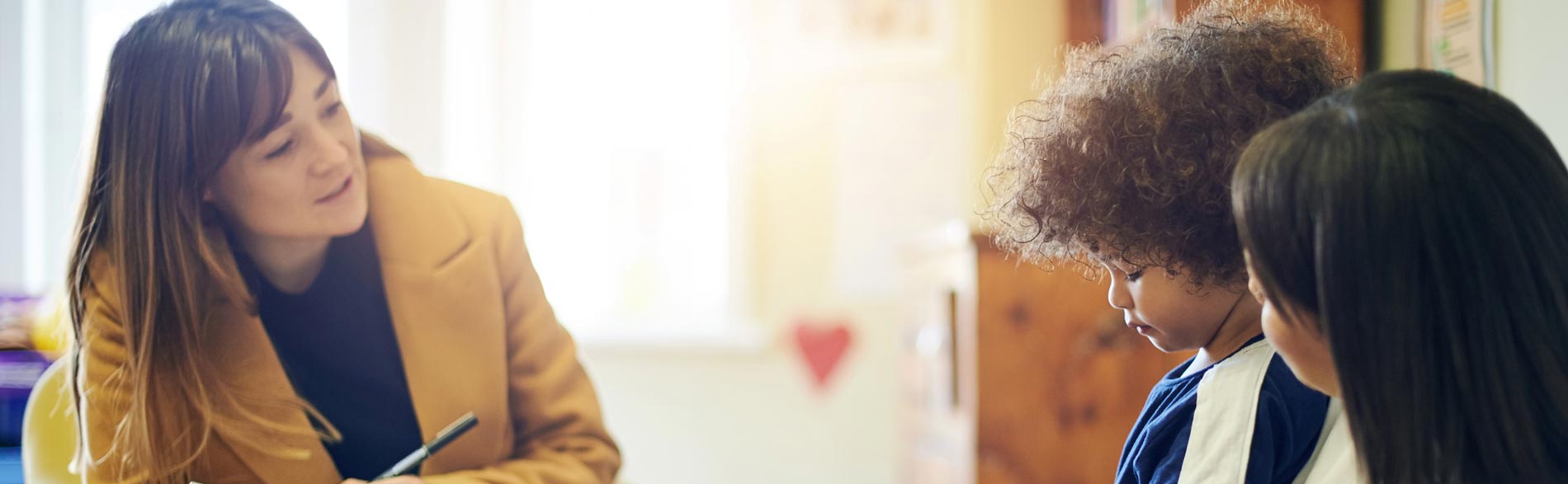 A clinician assesses a child for Autism Spectrum Disorder
