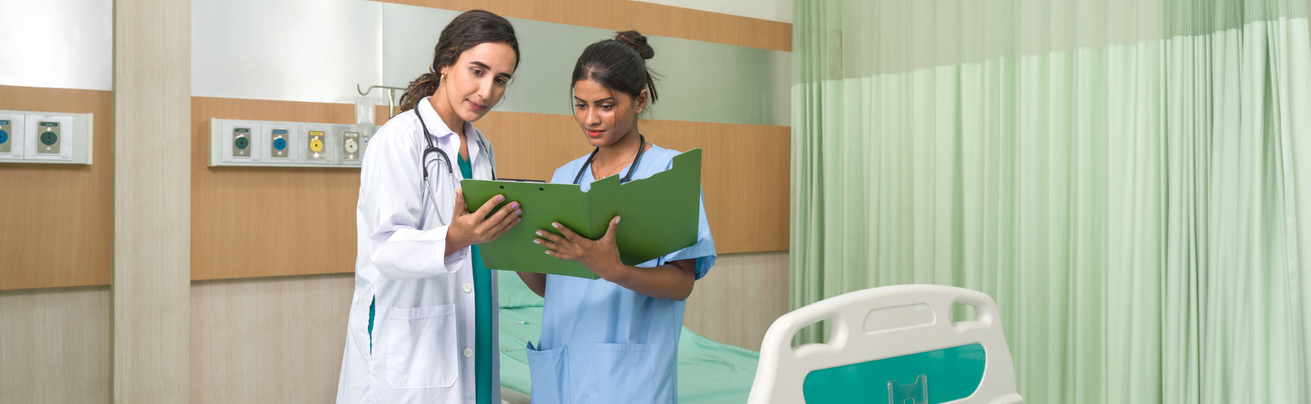 A nurse speaks to a doctor about a file in a Mexican hospital