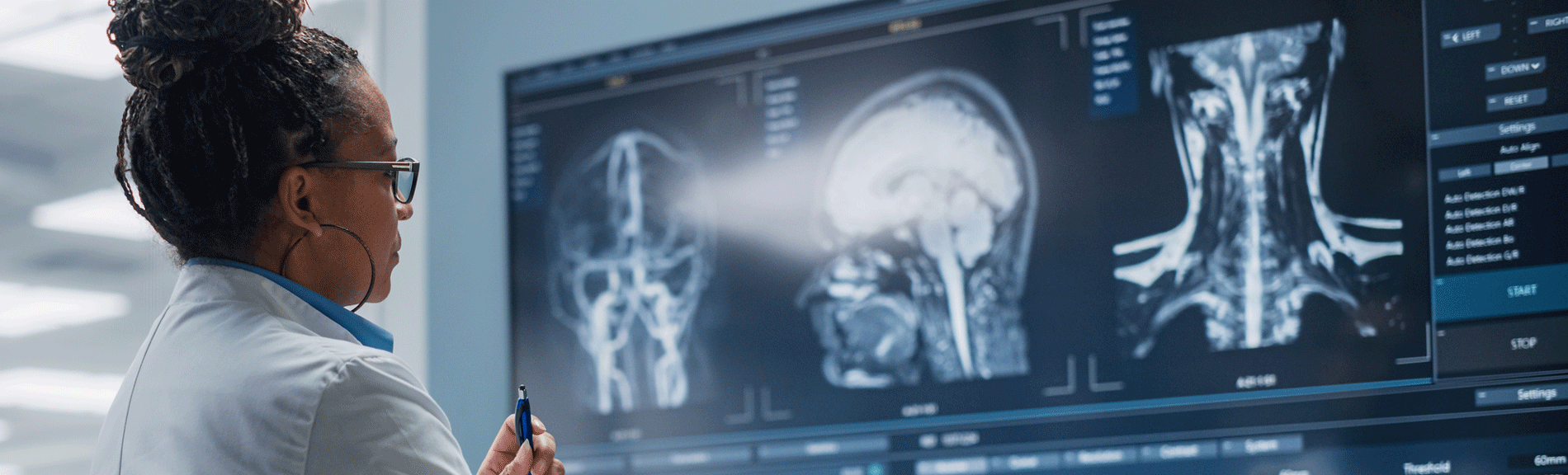 Female neurologist looks at brain and spinal cord scans
