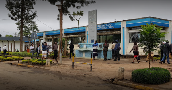 People waiting outside a clinic.