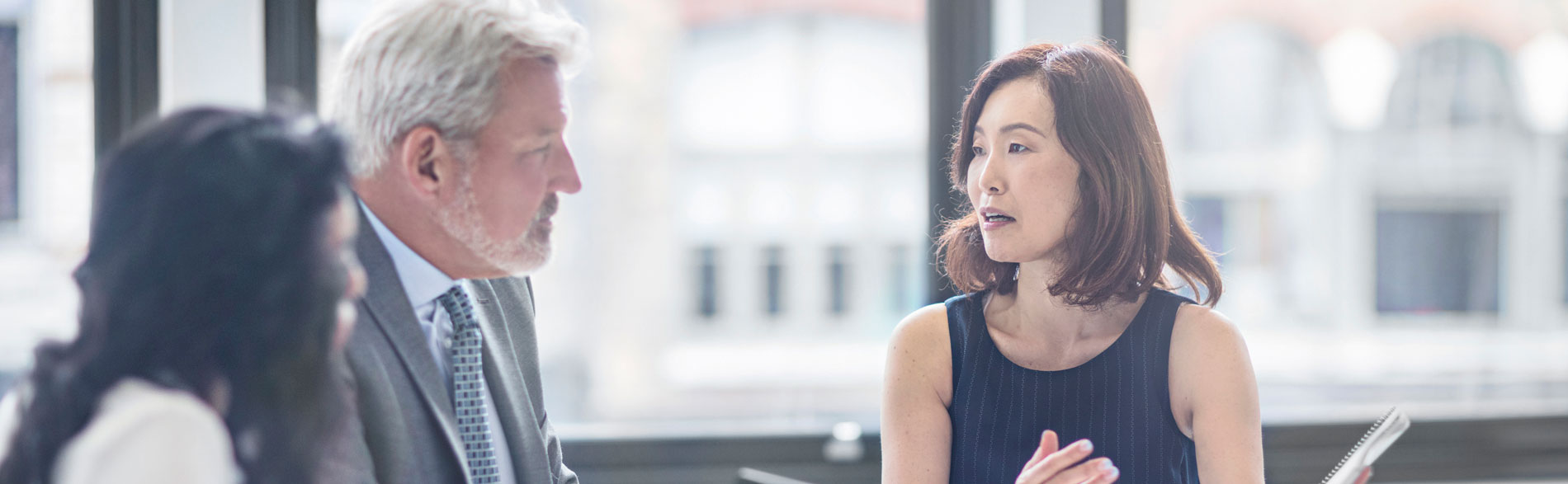 Three people having a consultancy meeting