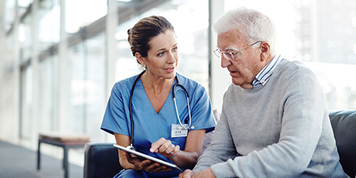 Nurse in discussion with older patient