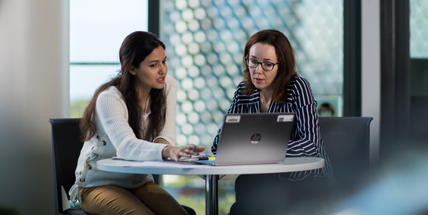 A nursing student discusses coursework with a clinician