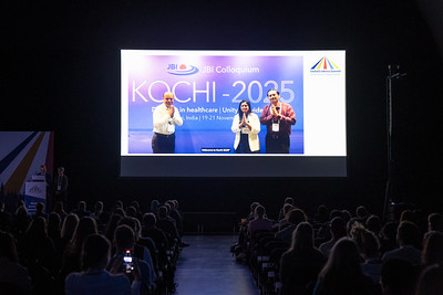 Crowd seated watching video presentation of JBI Kochi, the JBI Colloquium in 2025