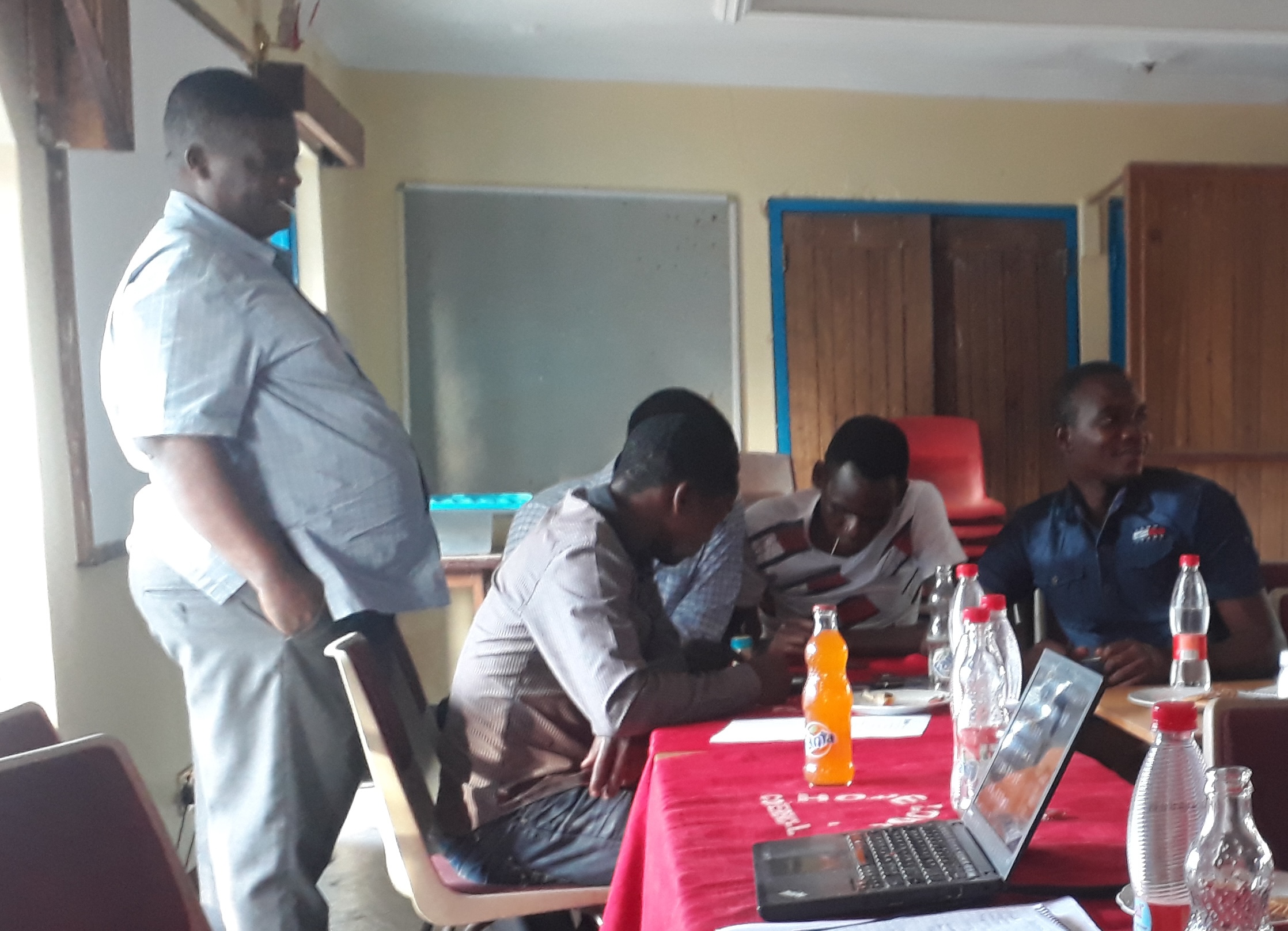 Project team is seated indoors at a working meeting