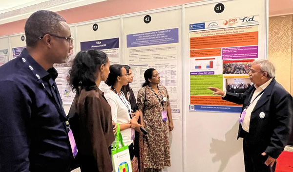 Dr Morankar Sudhakar explains a poster to attendees at Kochi 2025