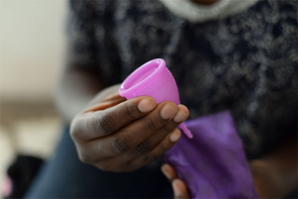 Hand holding a menstral cup