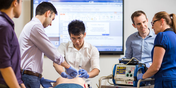 Student nurses practice a proceedure in a clinical setting