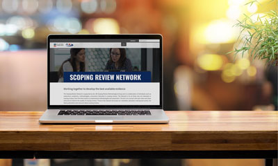 Laptop showing Scoping Reviews chapter on screen