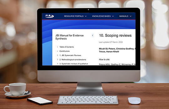 JBI Manual for Evidence Synthesis Scoping Reviews chapter open on the screen of a computer on a desktop