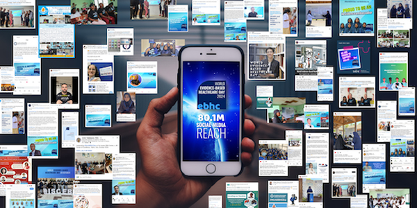 Little screen grabs from the digital engagement that occurred during World EBHC Day 2024 in the background, with a hand holding a phone in the foreground which displays the World EBHC Day logo with 80.1M social media reach