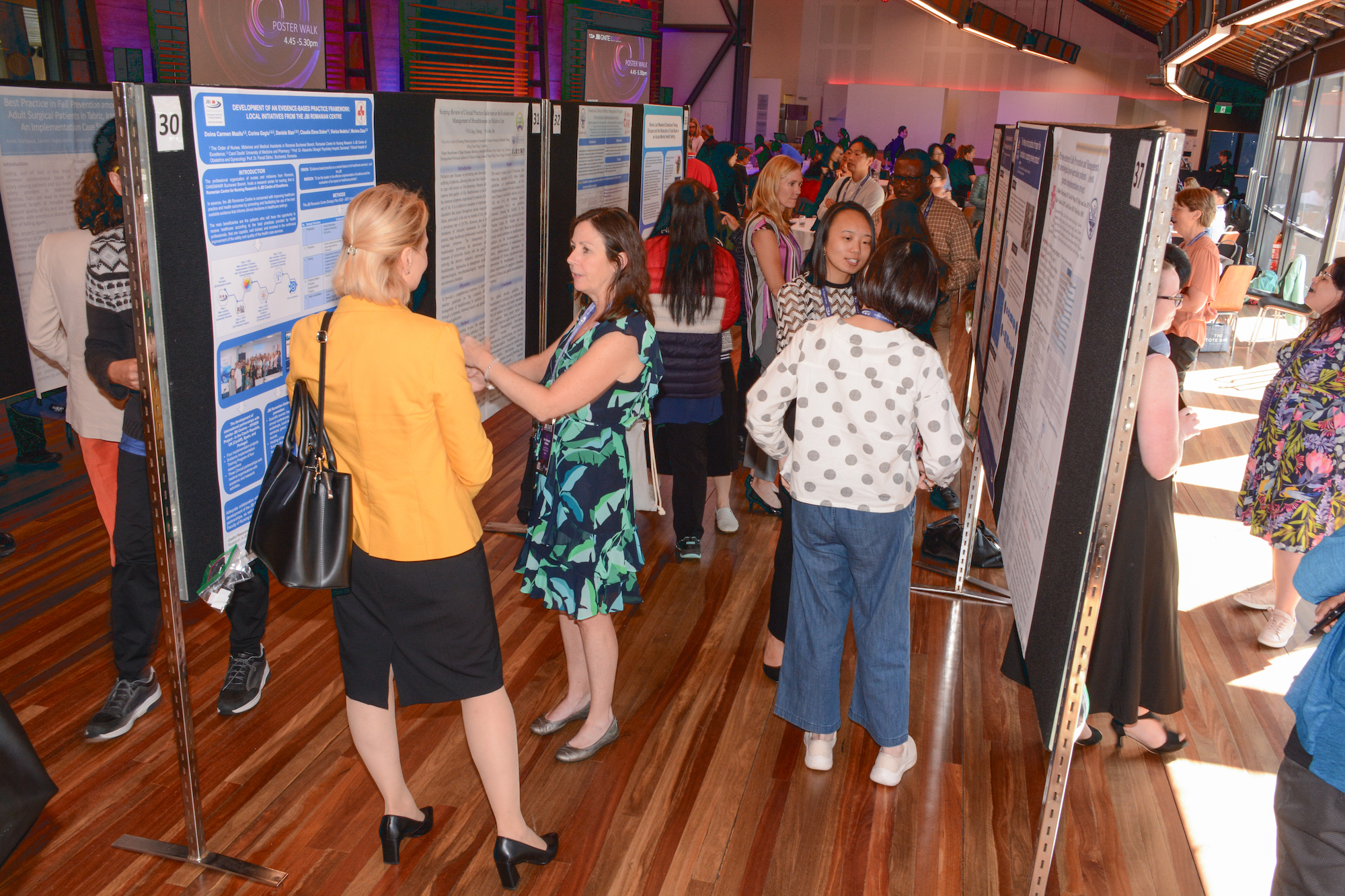 Delegates at JBI iGNITE study academic posters on display