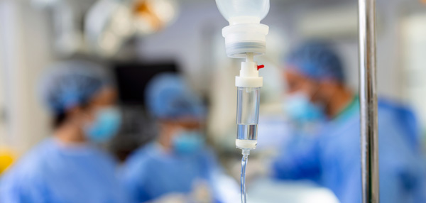 Close up of an intravenous bag and drip in the theatre setting