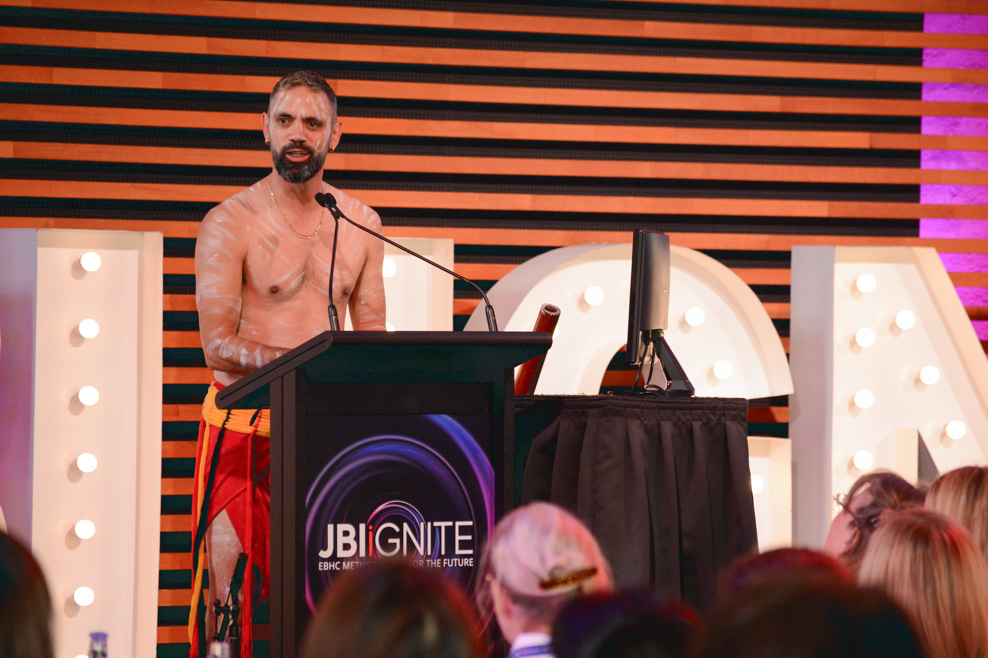 Jack Buckskin stands at podium to welcome delegates to Country