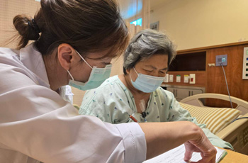 A clinician goes through a sleep questionaire with a patient