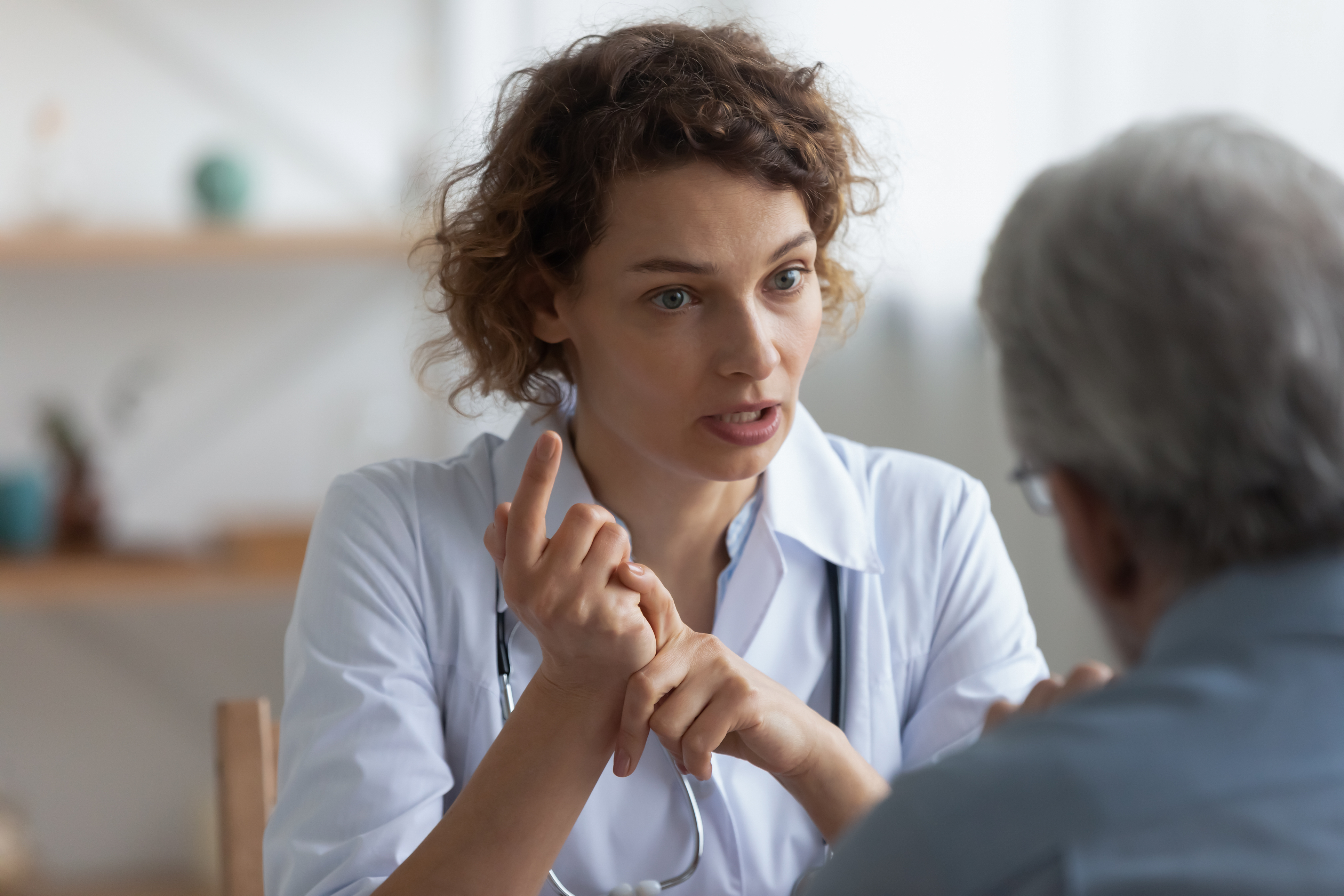 Clinician talks with senior man