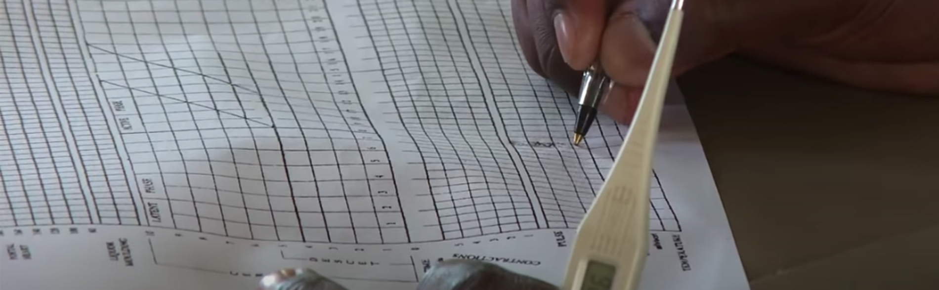 Healthcare worker fills out the partogram