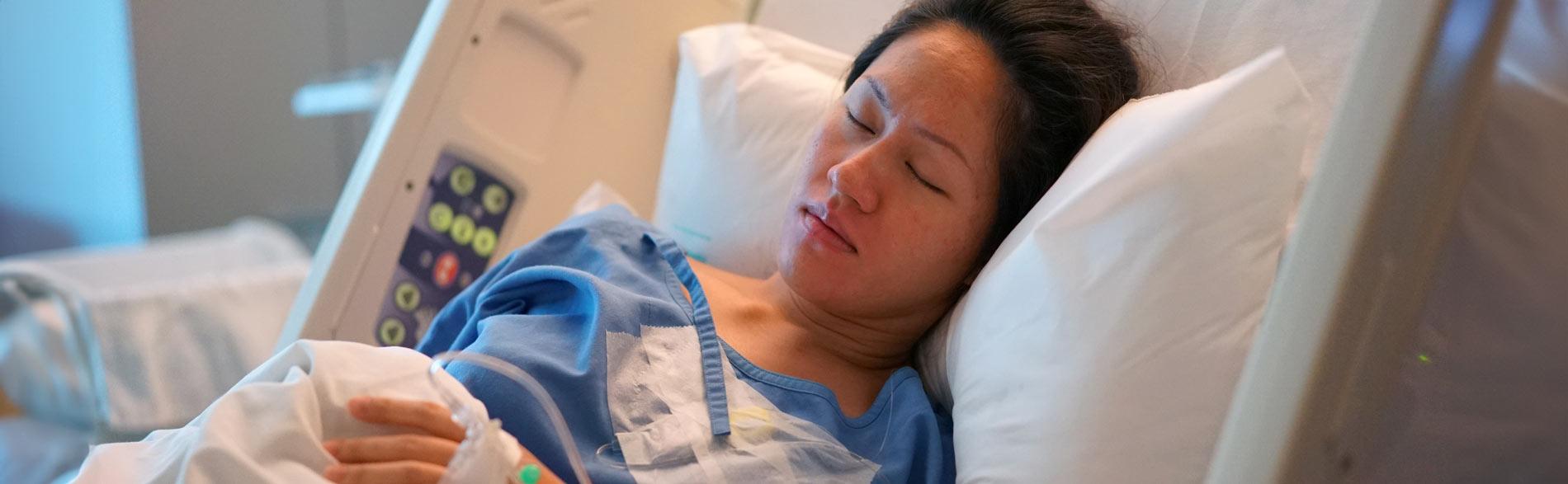 Pregnant lady sleeps in a hospital bed