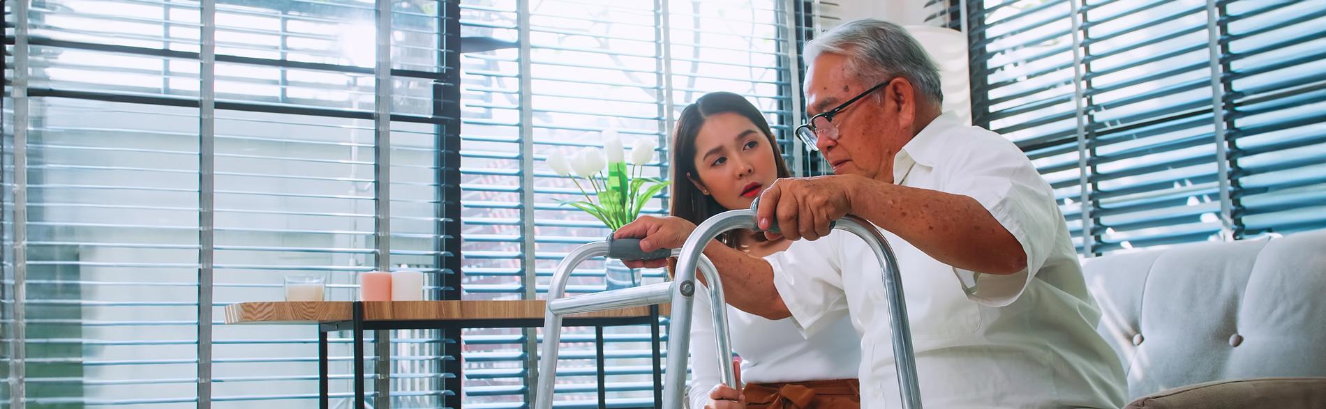 A patient is encouragec by a clinician to walk with a frame after a cononary angiographic procedure