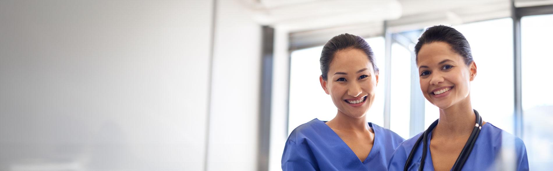 Nurses smiling into the camera