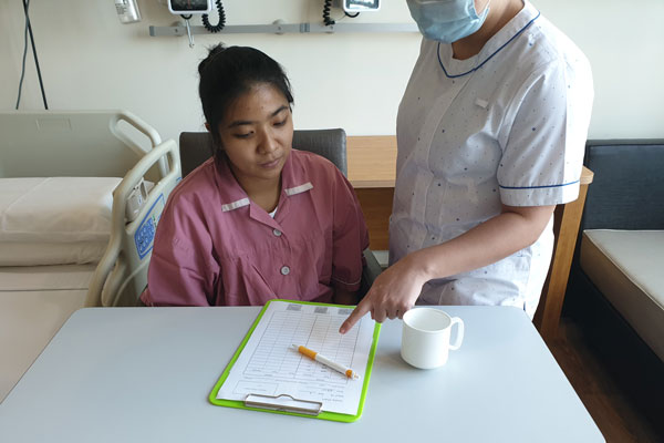 Health care worker explaining a form to a patient
